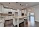 Spacious kitchen featuring a center island, white cabinets, granite countertops and stainless appliances at 9270 Colham Dr, Cumming, GA 30041
