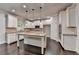 Gourmet kitchen with white cabinets, granite countertops, and a large center island at 9270 Colham Dr, Cumming, GA 30041