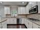 Bright kitchen with granite countertops, stainless steel appliances, and access to an outdoor area at 9270 Colham Dr, Cumming, GA 30041