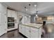 Stylish kitchen featuring a granite island, stainless appliances and a double oven at 9270 Colham Dr, Cumming, GA 30041