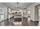 Spacious living area with a modern kitchen featuring a center island, seamlessly flowing for contemporary living at 9270 Colham Dr, Cumming, GA 30041