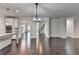 Open floor plan featuring a modern kitchen and adjacent living area with hardwood floors at 9270 Colham Dr, Cumming, GA 30041