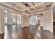 Elegant living room featuring coffered ceilings and hardwood floors offering an open floor plan at 9270 Colham Dr, Cumming, GA 30041