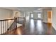 Bright loft area with hardwood floors, windows, and wrought iron staircase railing at 9270 Colham Dr, Cumming, GA 30041