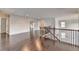 Loft featuring hardwood floors, neutral paint, staircase, and multiple entryways at 9270 Colham Dr, Cumming, GA 30041