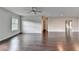 Spacious loft area with hardwood floors, natural light, and a ceiling fan at 9270 Colham Dr, Cumming, GA 30041