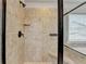 Tiled shower with frameless glass door, built in bench and shampoo nook at 9270 Colham Dr, Cumming, GA 30041