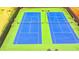 Two pristine blue tennis courts with green surround for recreational activities at 9270 Colham Dr, Cumming, GA 30041
