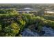 Overhead view of wooded neighborhood featuring a small pond and lush foliage at 2623 Grapevine Cir # 602, Cumming, GA 30041