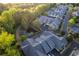 Bird's-eye view of townhomes with well-maintained landscaping and a tranquil pond at 2623 Grapevine Cir # 602, Cumming, GA 30041