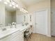 Bathroom featuring double sinks, a vanity area, and neutral tile flooring at 2623 Grapevine Cir # 602, Cumming, GA 30041