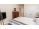 Well-lit bedroom with a large bed, dresser, and a view to another room at 2623 Grapevine Cir # 602, Cumming, GA 30041