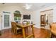 Open dining room featuring wood floors, a rustic dining table, and an open layout leading to other living spaces at 2623 Grapevine Cir # 602, Cumming, GA 30041