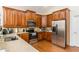 Well-equipped kitchen featuring stainless steel appliances, ample wooden cabinetry, and granite countertops at 2623 Grapevine Cir # 602, Cumming, GA 30041
