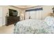 Comfortable main bedroom showing a television, full-length mirror and neutral color palette at 2623 Grapevine Cir # 602, Cumming, GA 30041