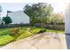 Landscaped backyard featuring a stone walkway, lush grass, and a fenced perimeter at 312 Burdock Trce, Woodstock, GA 30188