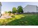 Large backyard with plenty of grass, mature trees, a concrete patio and wood fence at 312 Burdock Trce, Woodstock, GA 30188