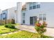 Backyard featuring a sliding glass door, a grassy lawn, flowers, and mature landscaping at 312 Burdock Trce, Woodstock, GA 30188