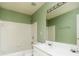 Bathroom featuring a tub/shower combo, toilet, and a double sink vanity with lighting and a large mirror at 312 Burdock Trce, Woodstock, GA 30188