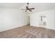 Large bedroom featuring carpeted floors, ceiling fan, and an ensuite bathroom at 312 Burdock Trce, Woodstock, GA 30188
