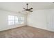 Bedroom with neutral carpet, ceiling fan, and plenty of natural light at 312 Burdock Trce, Woodstock, GA 30188