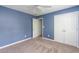 Bedroom with carpet, a window, blue walls, and a double door closet at 312 Burdock Trce, Woodstock, GA 30188