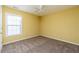 Bedroom with a ceiling fan, window with blinds, carpet, and yellow walls at 312 Burdock Trce, Woodstock, GA 30188