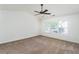 Spacious carpeted bedroom with ceiling fan and large window for ample natural light at 312 Burdock Trce, Woodstock, GA 30188