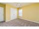 Bedroom with a ceiling fan, window with blinds, carpet, and yellow walls at 312 Burdock Trce, Woodstock, GA 30188