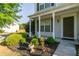 Inviting front porch with landscaped garden and well-maintained lawn at 312 Burdock Trce, Woodstock, GA 30188