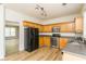 Well-equipped kitchen with wood cabinetry, stainless steel appliances, and a modern aesthetic at 312 Burdock Trce, Woodstock, GA 30188