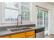 Close-up of kitchen sink with stainless steel appliances and view to the backyard at 312 Burdock Trce, Woodstock, GA 30188
