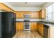 Kitchen featuring sleek stainless steel appliances and ample wooden cabinets at 312 Burdock Trce, Woodstock, GA 30188