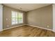 Comfortable living room with hardwood floors and a large window at 312 Burdock Trce, Woodstock, GA 30188