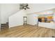 Bright living room featuring wood floors, high ceilings with a ceiling fan, and an open floor plan to the kitchen at 312 Burdock Trce, Woodstock, GA 30188