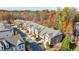Aerial view of a residential neighborhood showcasing well-maintained townhomes and lush trees at 5260 Cresslyn Rdg, Alpharetta, GA 30005