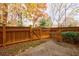 Cozy fenced backyard featuring a private gate and lush foliage, offering a serene outdoor space at 5260 Cresslyn Rdg, Alpharetta, GA 30005