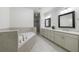 Bathroom features a soaking tub, tiled floor and double sink vanity at 5260 Cresslyn Rdg, Alpharetta, GA 30005