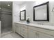 Modern bathroom featuring double sinks, framed mirrors, and a glass door shower at 5260 Cresslyn Rdg, Alpharetta, GA 30005