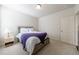 Neutral bedroom featuring a cozy bed with a soft, patterned blanket and a classic lamp on a bedside table at 5260 Cresslyn Rdg, Alpharetta, GA 30005