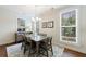 Charming dining room with hardwood floors, chandelier, and large windows at 5260 Cresslyn Rdg, Alpharetta, GA 30005