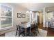 Dining room with hardwood floors, modern lighting, and access to kitchen at 5260 Cresslyn Rdg, Alpharetta, GA 30005