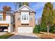 Charming brick townhome with a two-car garage, complemented by manicured landscaping and a bright, inviting facade at 5260 Cresslyn Rdg, Alpharetta, GA 30005