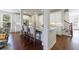 Bright kitchen features an island with seating, white cabinetry, and hardwood floors at 5260 Cresslyn Rdg, Alpharetta, GA 30005