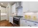 Chef's kitchen featuring stainless steel appliances, granite counters, and modern white cabinetry at 5260 Cresslyn Rdg, Alpharetta, GA 30005