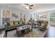 Bright living room with hardwood floors, sofa, and large windows at 5260 Cresslyn Rdg, Alpharetta, GA 30005