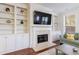 Comfortable living room with built-in bookshelves, fireplace, and hardwood floors at 5260 Cresslyn Rdg, Alpharetta, GA 30005