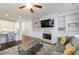 Open concept living room with fireplace, built-in shelves, and hardwood floors at 5260 Cresslyn Rdg, Alpharetta, GA 30005