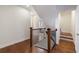 Staircase with wooden banister and hardwood floors leading to upper level at 5260 Cresslyn Rdg, Alpharetta, GA 30005