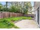 Fenced backyard features an overgrown lawn and a concrete patio at 1218 Matt Moore Ct, Lithia Springs, GA 30122